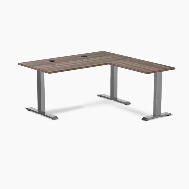 Desky Zero L-shape office desk with Jarrah Legno laminate top, Space Gray steel frame, and grommets.