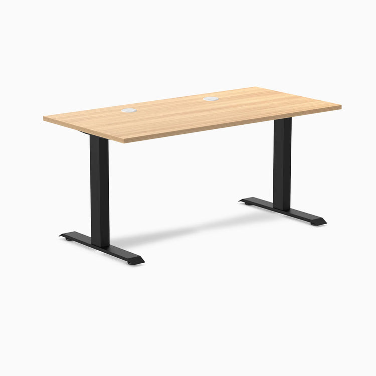 Desky Zero fixed-height office desk with a Sublime Teak laminate top, two grommets, and matte black steel frame.