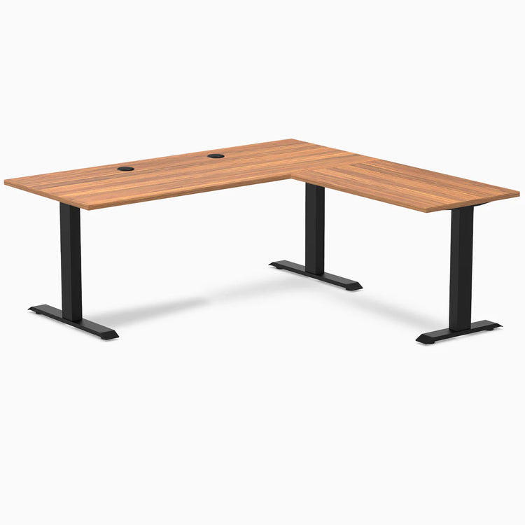 Prime Oak laminate L-shape office desk with matte black steel frame and grommets.