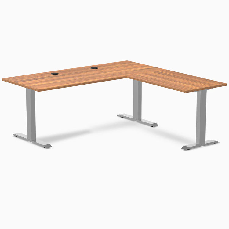 Prime Oak L-shape office desk with gray steel frame, grommets, and minimalist design.