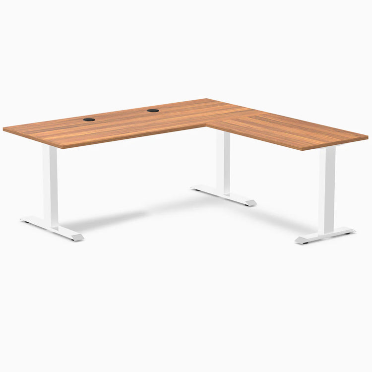 Prime Oak laminate L-shape office desk with white steel frame and grommets.