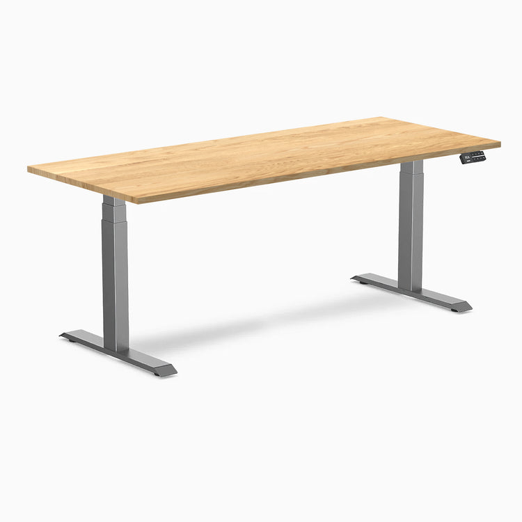 Desky Dual 72x30 inch White Oak hardwood sit-stand desk with Space Gray legs and control panel.