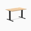 Desky Zero fixed-height office desk with Sublime Teak laminate top, two grommets, and matte black steel frame.
