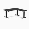 Black Desky L-Shape Laminate Sit Stand Desk with grommets and matte black frame.