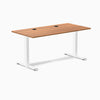 Desky Zero fixed height office desk with Prime Oak laminate top, white steel frame, and two grommets.
