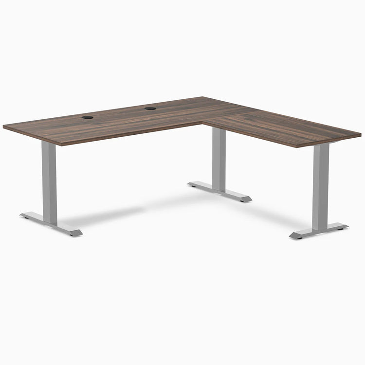 Desky Zero Laminate L-Shape Office Desk with Jarrah Legno top, gray steel frame, and grommets.
