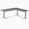 Desky Zero Laminate L-Shape Office Desk with Jarrah Legno top, gray steel frame, and grommets.