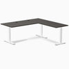 Desky Zero L-shape office desk with burnished wood laminate top, white steel frame, and grommets.