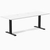 Desky Zero fixed height office desk with a white laminate top, matte black steel frame, and two grommets.