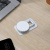 Phone holder on a wooden desk with a laptop and smartphone in the background