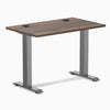 Desky Zero Mini fixed-height desk with Jarrah Legno top, Space Gray legs, and two grommets.