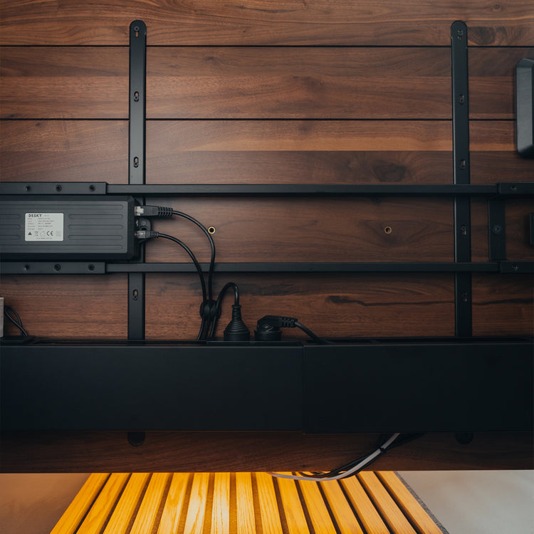 Black integrated cable channel and power set up under desk