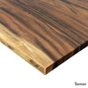 Close-up of a Desky Pheasantwood hardwood desk top, showcasing its natural wood grain and exposed edge.