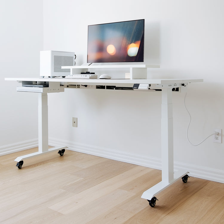 White standing desk setup with cable channel