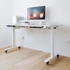 White standing desk setup with cable channel