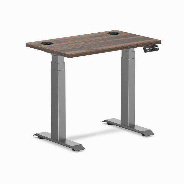 Desky Dual Mini sit-stand desk with Jarrah Legno top, Space Gray legs, and grommets.