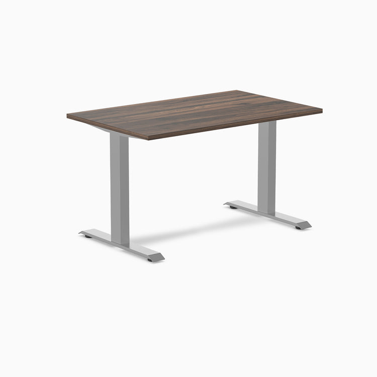 Desky Zero laminate office desk with a dark wood-grain top and silver steel frame.